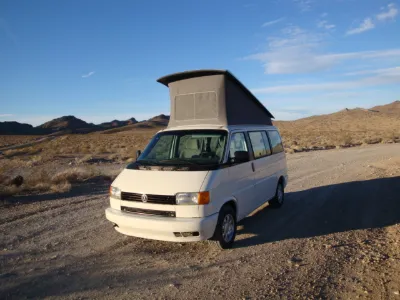 VW Eurovan camper with pop-top raised in the desert