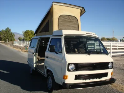 White VW Vanagon Westfalia with pop-top raised