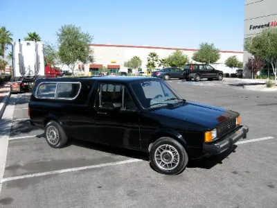 Black VW Caddy with camper shell